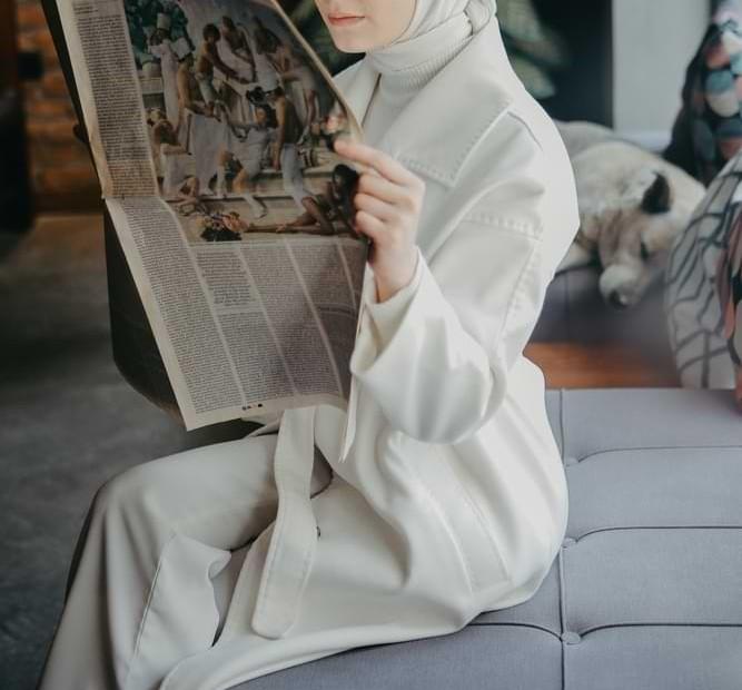Femme voilée qui lit le journal